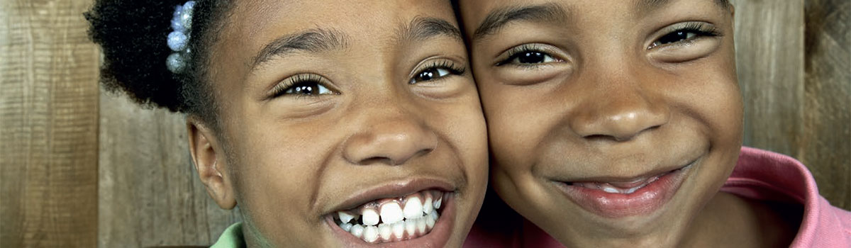 two smiling children who are looking at the camera